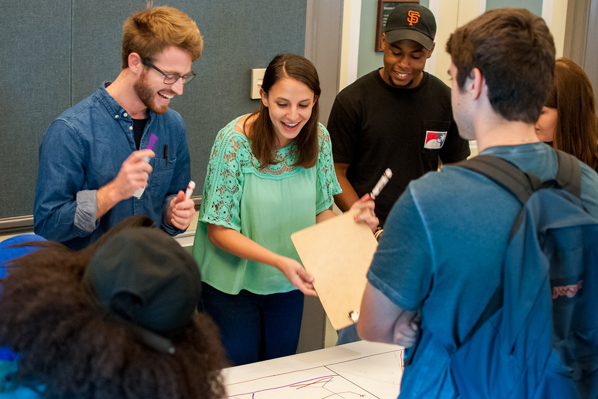 Group of students from the NIH Amgen Scholars program work together on a project.