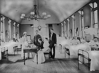 Dr. Joseph Goldberger seated at a table in a hospital.