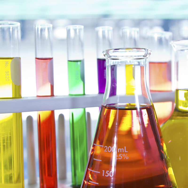 Laboratory glassware with colorful liquid.