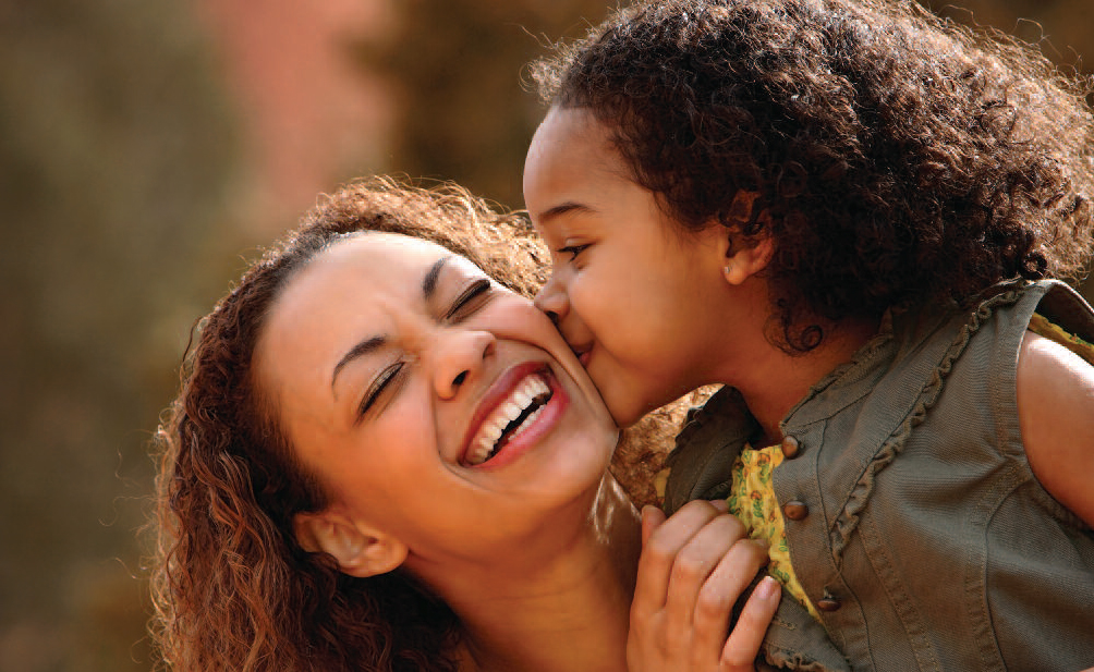 Mother and daughter laughing together.