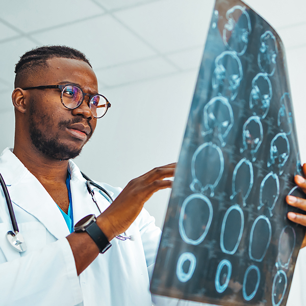 A radiologist reviewing a computed tomography (CT) scan of a patient's brain