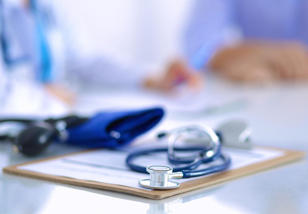 Image of a stethoscope on top of a pad of paper