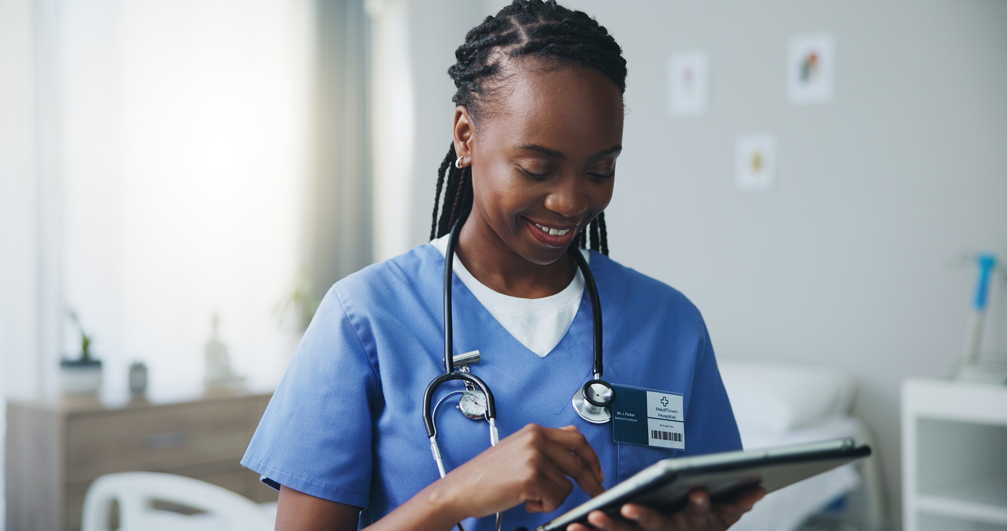 Image of a doctor looking at a tablet device.