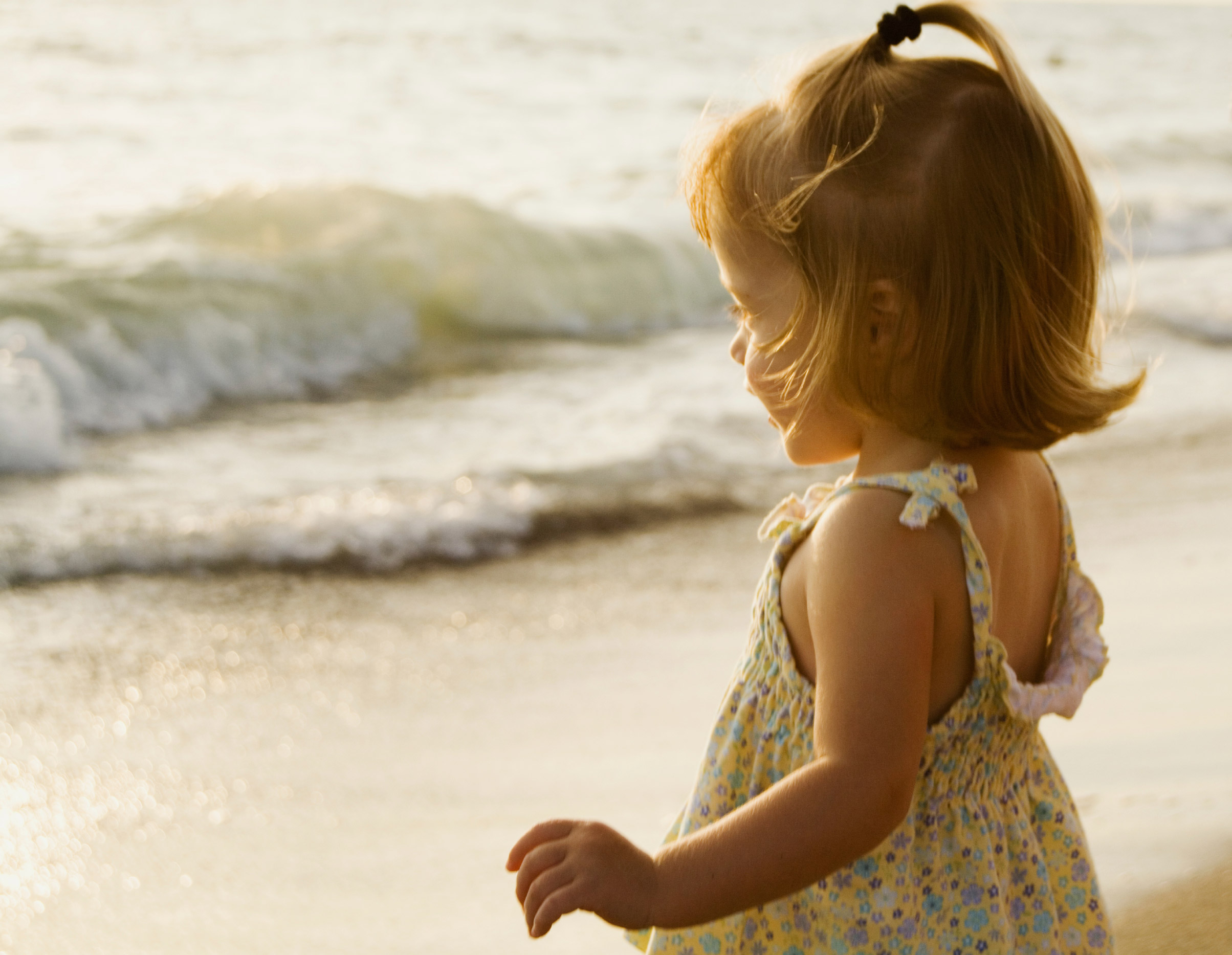 Picture of a little girl standing by the ocean