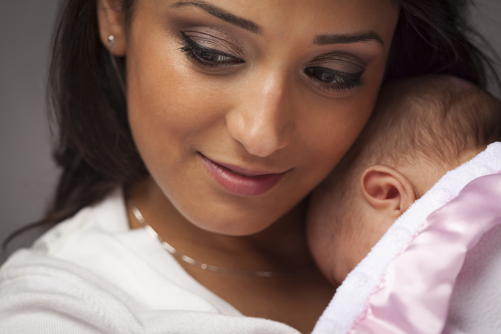 Woman holding newborn. 