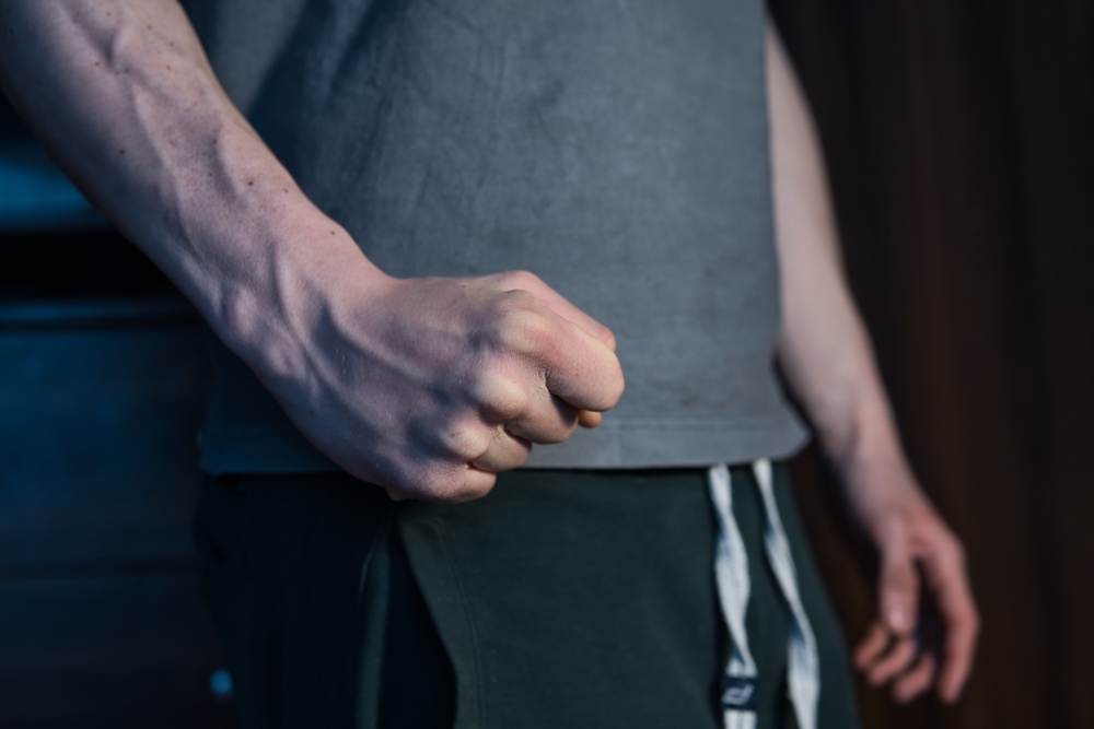 Close-up of a man’s fist with veins showing on arm.