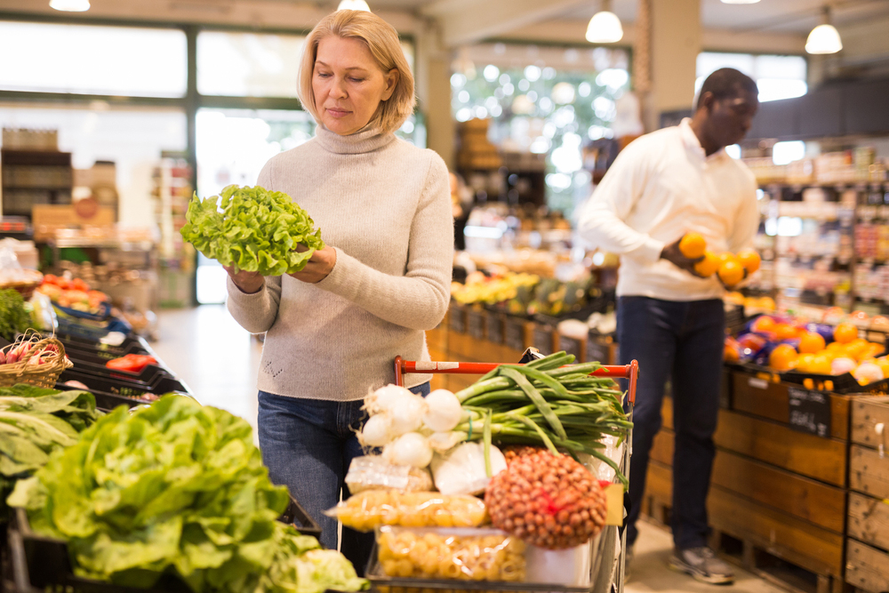Middle-aged woman shopping for fresh vegetables. Middle-aged woman shopping for fresh vegetables.