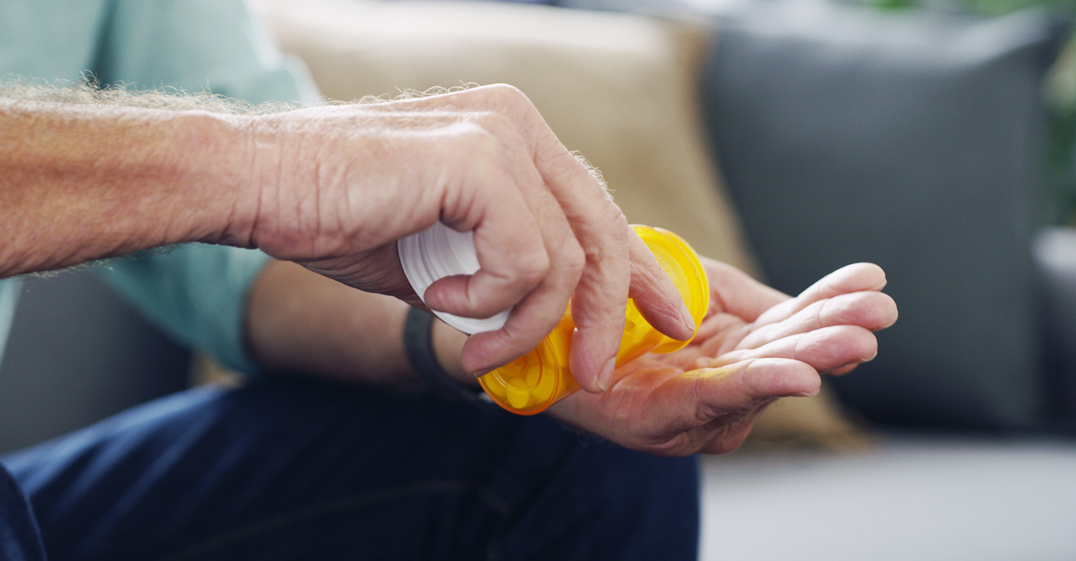 Shot of an unrecognisable senior man taking medication at home