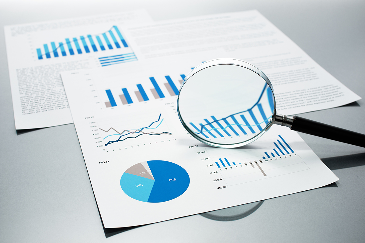 Report graphs enlarged by magnifying glass.