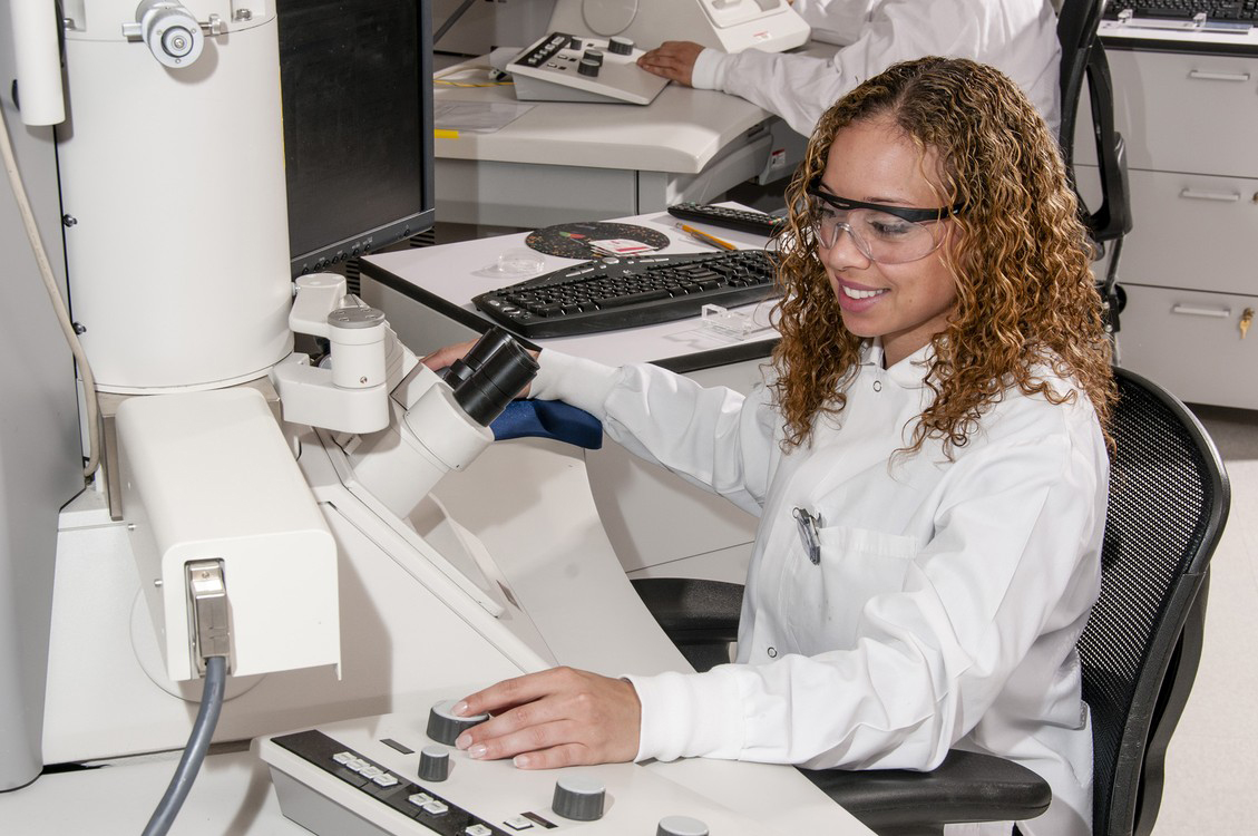 Technician using an Electron Microscope.