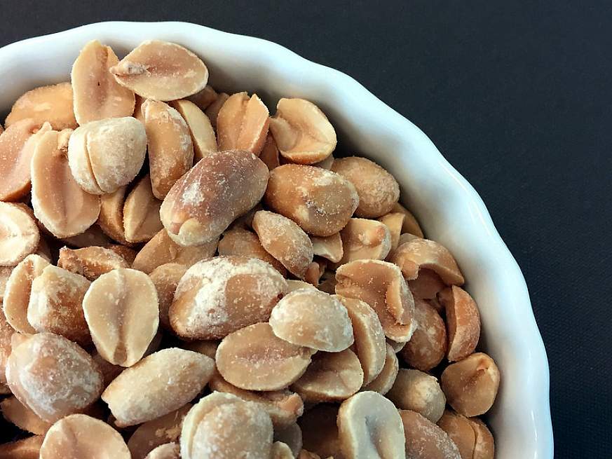A bowl of peanuts. A bowl of peanuts.
