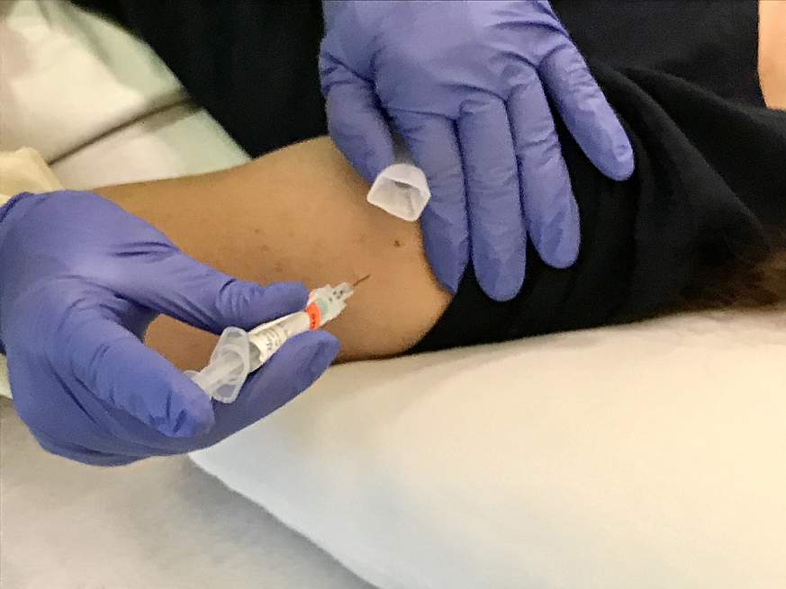 Image of a person getting a shot Image of a person getting a shot