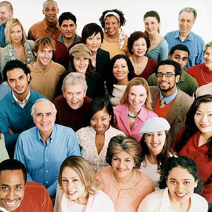 A group of people smiling and looking up toward the camera A group of people smiling and looking up toward the camera.