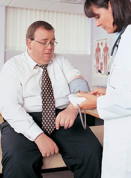 a photo of an obese man having his blood pressure taken by a doctor a photo of an obese man having his blood pressure taken by a doctor