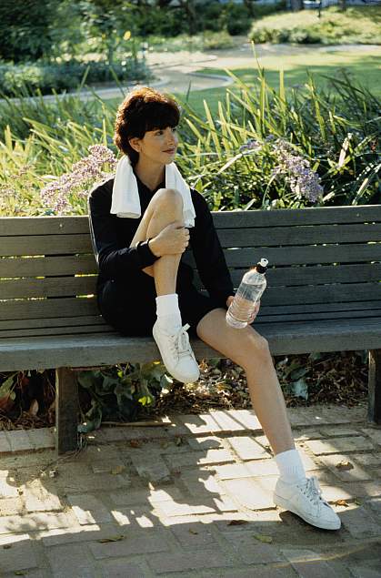 A young woman relaxing on a bench A young woman relaxing on a bench