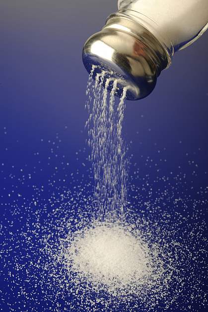 Photo of a salt shaker and spilled salt Photo of a salt shaker and spilled salt