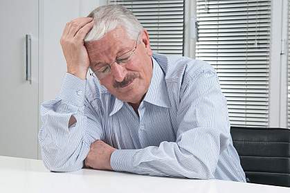 Photo of a man suffering with a migraine headache Photo of a man suffering with a migraine headache