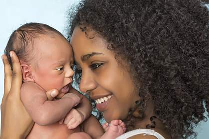 Photo of a newborn baby and mother Photo of a newborn baby and mother