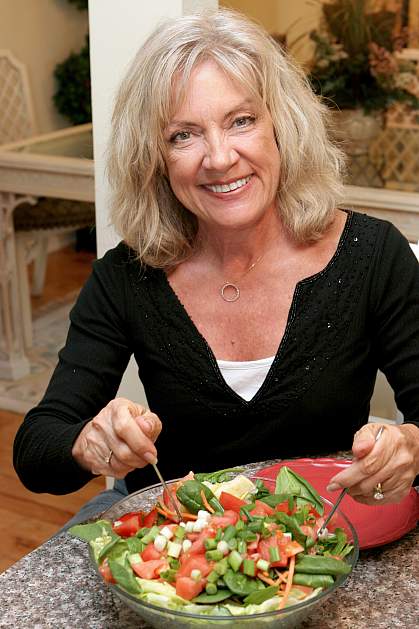 Older woman eating a salad Older woman eating a salad