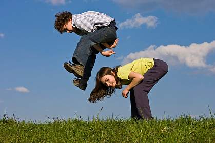 Photo of a boy and a girl playing leap frog Photo of a boy and a girl playing leap frog