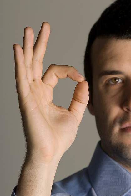 Photo of a man making the hand gesture for OK Photo of a man making the hand gesture for OK