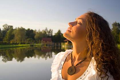 Photo of woman taking a deep breath Photo of woman taking a deep breath