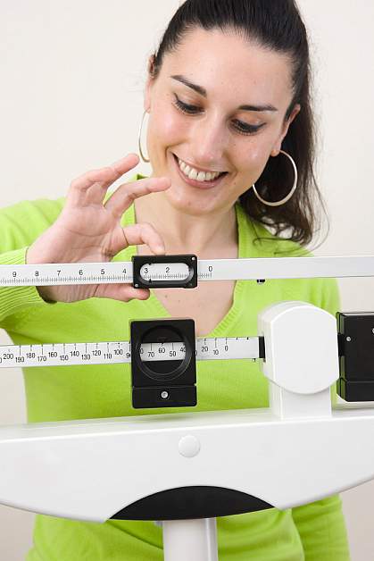 Photo of woman on a scale Photo of woman on a scale