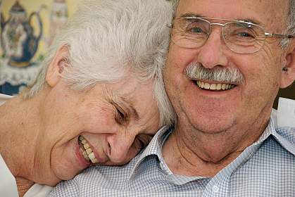 Photo of a happy senior couple, the woman with her head on his shoulder Photo of a happy senior couple, the woman with her head on his shoulder