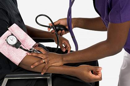 Photo of an arm in a blood pressure cuff Photo of an arm in a blood pressure cuff