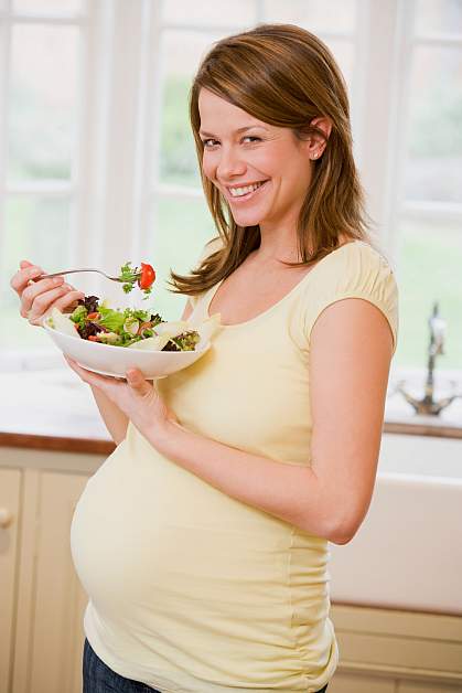 a photo of a pregnant woman eating a salad a photo of a pregnant woman eating a salad