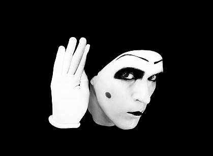 a photo of a mime holding his hand to his ear a photo of a mime holding his hand to his ear