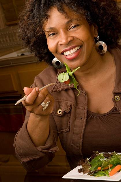 photo of a happy woman eating salad photo of a happy woman eating salad