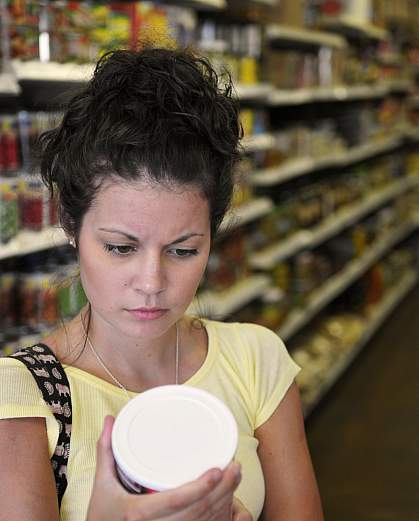 Woman reading a nutritional label Woman reading a nutritional label.