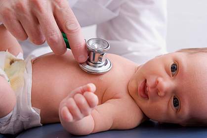 Photo of a doctor listening to an infant's chest with a stethoscope Photo of a doctor listening to an infant's chest with a stethoscope