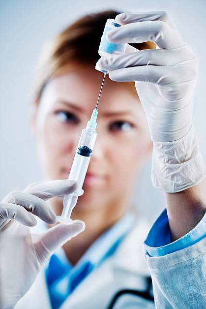 Photo of a woman preparing a flu shot Photo of a woman preparing a flu shot