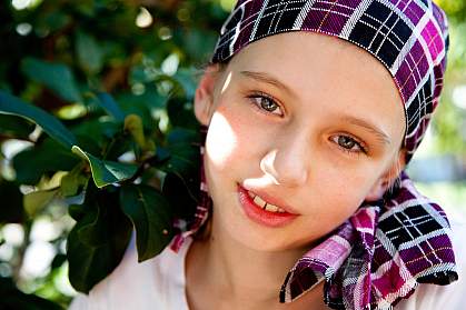 Photo of a young girl wearing a headscarf, smiling Photo of a young girl wearing a headscarf, smiling