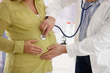 Photo of a pregnant woman with a stethoscope on her stomach Photo of a pregnant woman with a stethoscope on her stomach