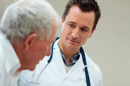 Photo of a physician talking with an older male patient Photo of a physician talking with an older male patient