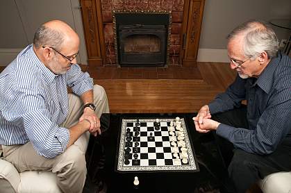 Photo of two older men playing chess Photo of two older men playing chess