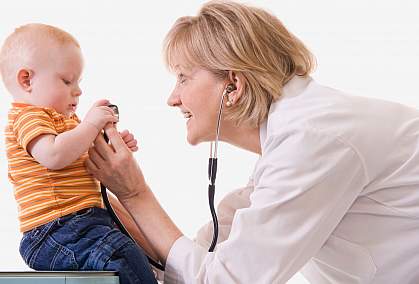 Photo of doctor examining toddler