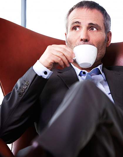 Photo of a man drinking coffee