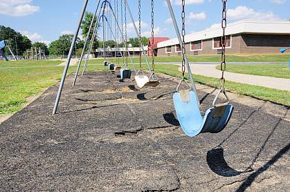 Photo of empty swings outside an elementary school Photo of empty swings outside an elementary school