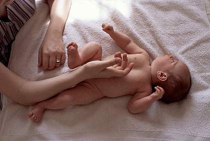 Photo of a mother’s hands touching her infant Photo of a mother’s hands touching her infant