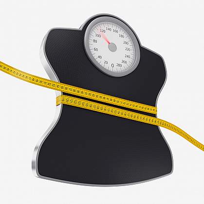 Photo of a yellow tape measure wrapped around a scale Photo of a yellow tape measure wrapped around a scale