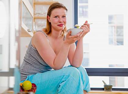 Photo of a woman eating yogurt Photo of a woman eating yogurt