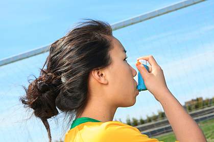 Photo of a girl using an inhaler for asthma Photo of a girl using an inhaler for asthma