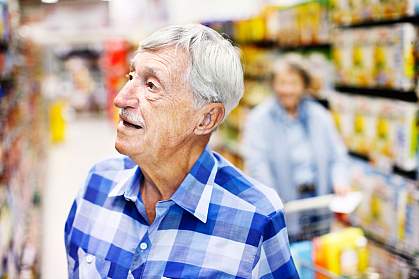 Photo of a confused man in a grocery store