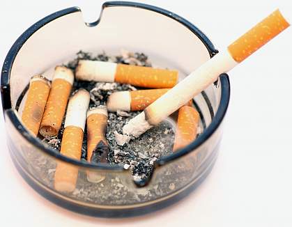 Photo of ashtray filled with cigarette stubs Photo of ashtray filled with cigarette stubs