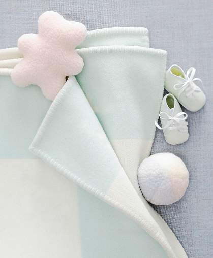 Photo of baby shoes, blanket and teddy bear Photo of baby shoes, blanket and teddy bear