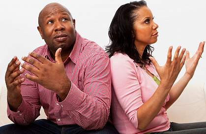 A man and woman throwing their hands up in frustration at each other A man and woman throwing their hands up in frustration at each other.